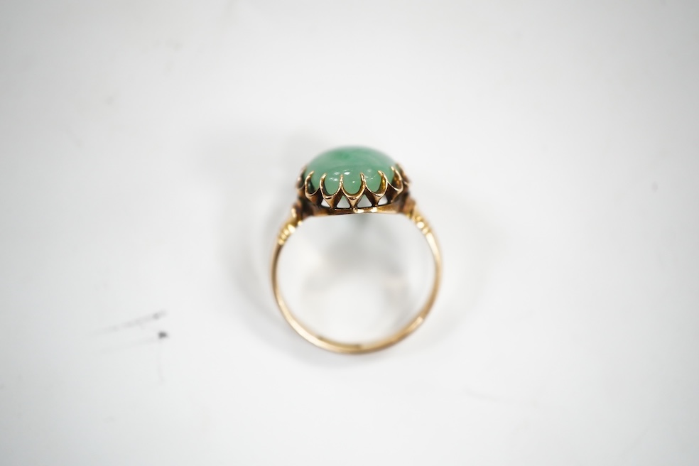 A mid 20th century yellow metal and single stone cabochon jade set ring, size Q, gross weight 5.6 grams. Condition - fair